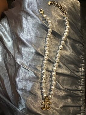 Damaged from velour bagCHANEL White Pearl Necklace with Gold Crystal CC Pendant.